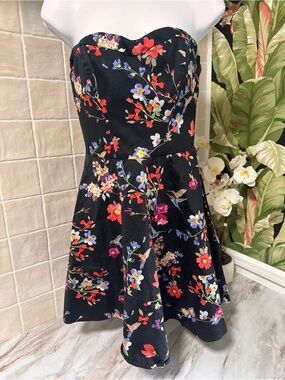 Express black strapless mini dress featuring a vibrant, multi-colored floral and
